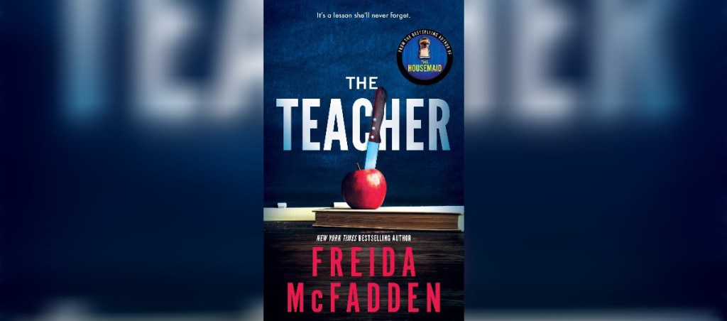 Picture of the book, "The Teacher" by Freida McFadden features a teacher desk with a red apple placed on top.  In the apple is a kitchen knife.